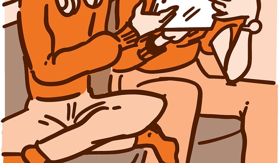 Imagen de un padre y su hijo mirando una tablet en el sofa