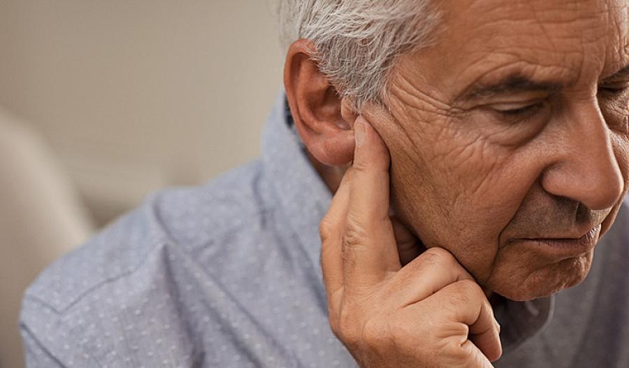 Imagen de un hombre sosteniendo los dedos en la oreja.